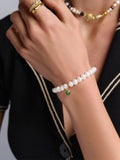 Wristband with White Pearls and Green Evil Eye Charm